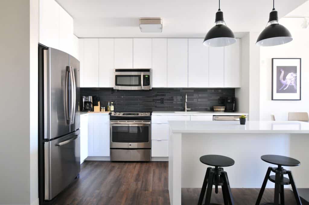 gray steel 3-door refrigerator near modular kitchen, clean house