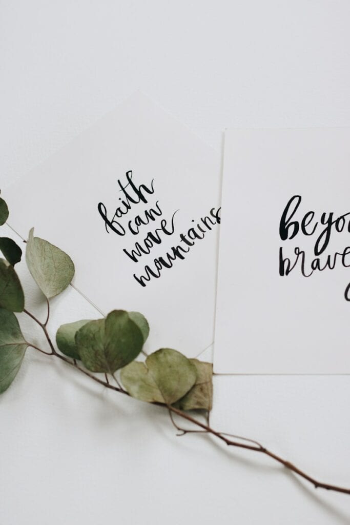 bible and healing can move mountains, green rose leaves and two cards flat lay photography